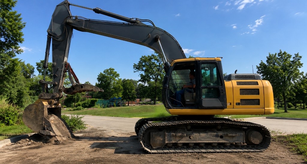 Yellow excavator on a construction site during site clearing